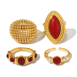 Set of four gold-plated stainless steel rings with red agate stones in vintage styles