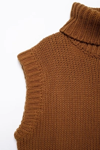 Detailed macro view of the caramel high-neck knit vest featuring ribbed shoulder texture