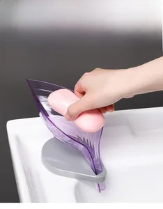 Leaf-shaped purple soap holder with drainage channel showing soap storage on sink