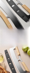 Detail of a rocking pizza cutter with a stainless steel blade and dual wooden handles