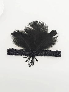 Detail of 1920s black sequin headband with soft feathers and dangling bead tassels