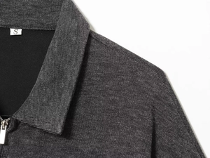 Close-up of soft dark grey knit vest featuring a silver zipper and lapel neckline details