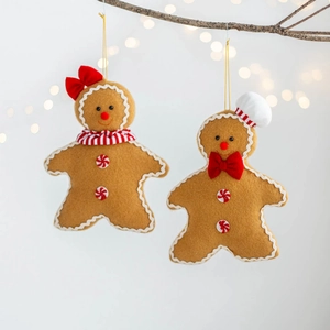 Detail of gingerbread man felt ornaments with candy buttons on rustic wood branches