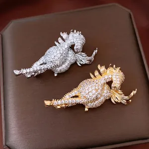 Exquisite 14K gold plated horse brooch set with sparkling cubic zirconia on a dark surface