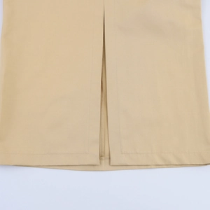Detail of the back slit hem on a beige elegant dress with premium twill fabric texture