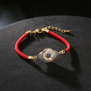 Adjustable red cord bracelet with gold plated pavé crystal evil eye charm for women