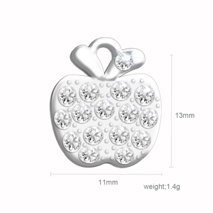 Macro shot of silver apple-shaped pendant with sparkling stones and size dimensions