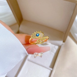 Gold-plated adjustable evil eye ring with white diamonds and blue pupil detail