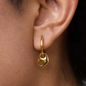 18k gold plated stainless steel hoop earrings with heart charm on a model