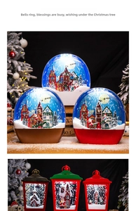 Detail of Christmas lantern snow globe with Santa and reindeer scenes and warm light