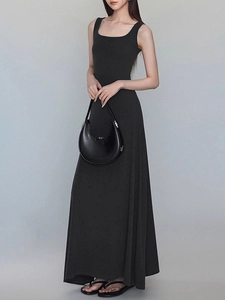 Minimalist black sleeveless square neck maxi dress with slim fit and flowing hemline