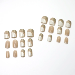 Short square press-on nails with cream gold geometric patterns and nude pink tones