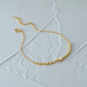 Detailed view of gold S925 sterling silver evil eye bracelet with marquise-cut zircon