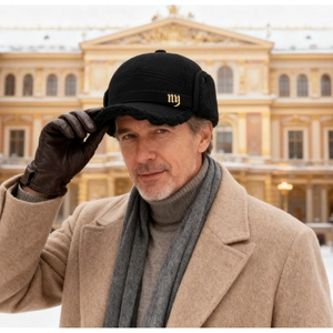Detail of wool baseball cap with earflaps and embroidery on a model in winter