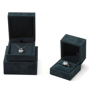 Dark green velvet jewelry box set featuring elegant silver necklace and ring with clear gems