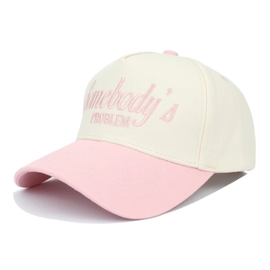 Detail of embroidered Somebody's Problem text on a two-tone trucker baseball cap