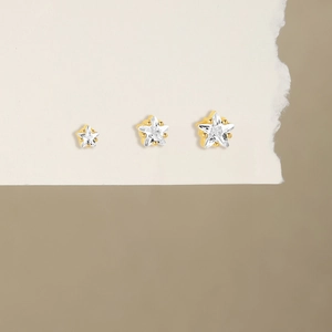 Detailed close-up of S925 sterling silver star studs in three sizes with gold finish