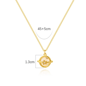 Close-up of golden planet pendant with mother of pearl and star details, 45cm plus 5cm chain