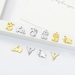 Minimalist animal pendants in gold and silver steel featuring elephant, cat and dog motifs