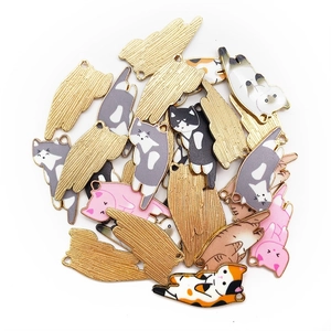 Pile of colorful alloy cat charms showing varied patterns and gold brushed texture back