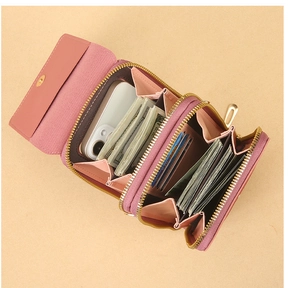 Detail of pink crossbody phone bag showing interior card slots and banknote storage