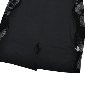 Close-up of black bodysuit with floral lace side panels and sheer mesh patchwork detail