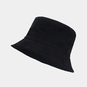 Close-up of black corduroy bucket hat showing thick vertical ribbed texture and soft fabric