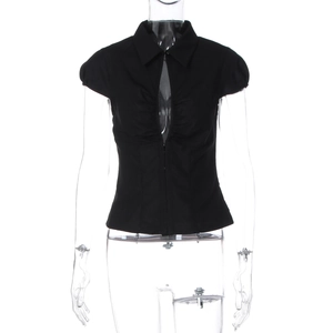 Detailed view of black slim-fit short sleeve top with polo collar and cut-out front design