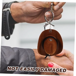 Close-up of a mini brown suede cowboy hat keychain with a durable metal ring