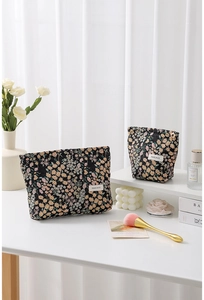 Detailed macro view showing floral jacquard fabric and high-quality zippers of travel bag set