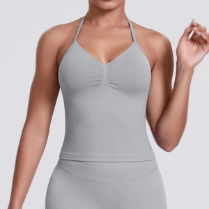 Detail view of seamless ribbed fabric and deep V-neckline on light grey sports bra
