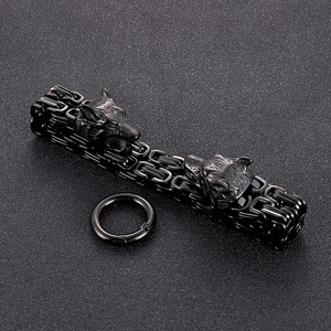 Detail of double wolf head bracelet with black Byzantine chain and spring ring clasp