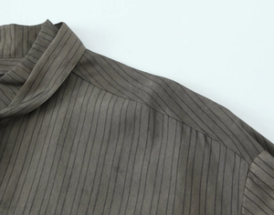 Macro detail of high-quality striped fabric collar and shoulder seams on a casual shirt