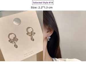 Detail of silver drop earrings with bow design and waterdrop pendant size 2.2x1.3CM