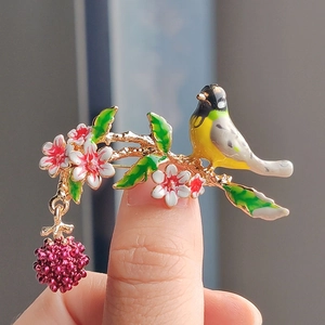 Pastoral enamel bird and raspberry brooch with floral design in gold alloy finish