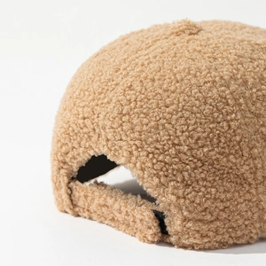 Detailed macro shot of the warm camel sherpa fleece texture on a baseball cap