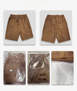 Detail view of tan men's quick-dry mesh shorts with drawstring waist and retail packaging