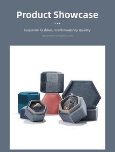 Detail of hexagonal velvet jewelry boxes showing interior slots for rings and necklaces