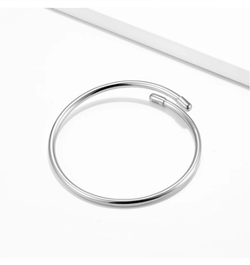 Macro shot of the S925 hallmark engraving on a minimalist sterling silver open bangle