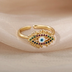 Detailed close-up of golden adjustable evil eye ring with colorful sparkling crystals