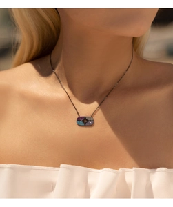 Close-up of S925 silver necklace with a black geometric pendant and colorful micro-pave crystals