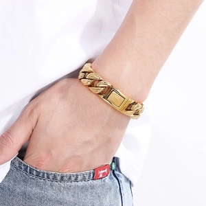 Close-up of a 15mm gold Cuban chain bracelet with textured links and a polished clasp