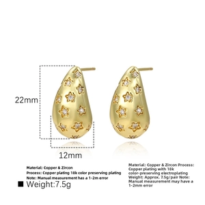 Macro detail of 18k gold plated teardrop earrings with inlaid cubic zirconia stars