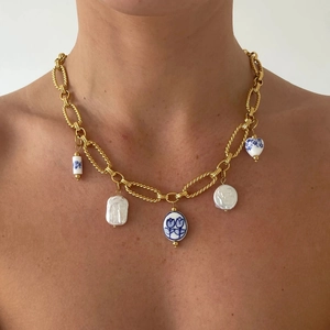 Gold chunky chain necklace featuring baroque pearls and blue floral ceramic heart pendants