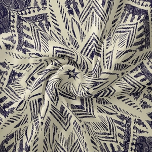 Detailed close-up of bohemian mandala tapestry fabric with navy paisley patterns