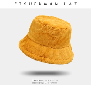 Close-up of bright yellow plush fisherman hat with soft faux fur texture for winter