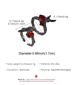 Macro detail of gothic punk raven head rings with red gemstones and zinc alloy texture