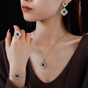 Detailed set of silver zircon jewelry featuring navy blue center stones and floral patterns