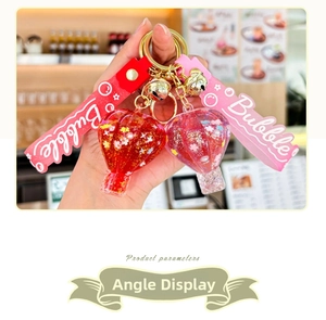 Detail showing hot air balloon keychains with sequins, gold bells, and Bubble wrist strap