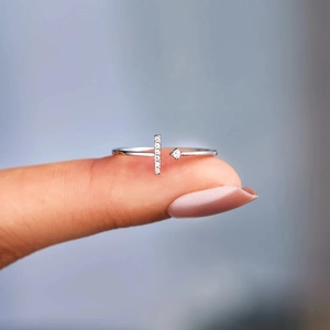 Close-up of S925 sterling silver T-shaped ring with pavé zircons worn on finger
